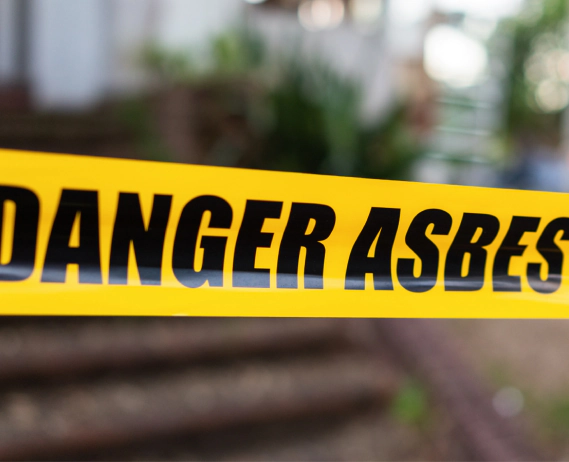 danger asbestos yellow tape closeup