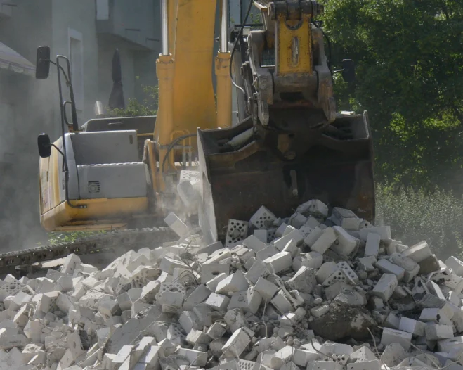 small demolition with a yellow contruction machine